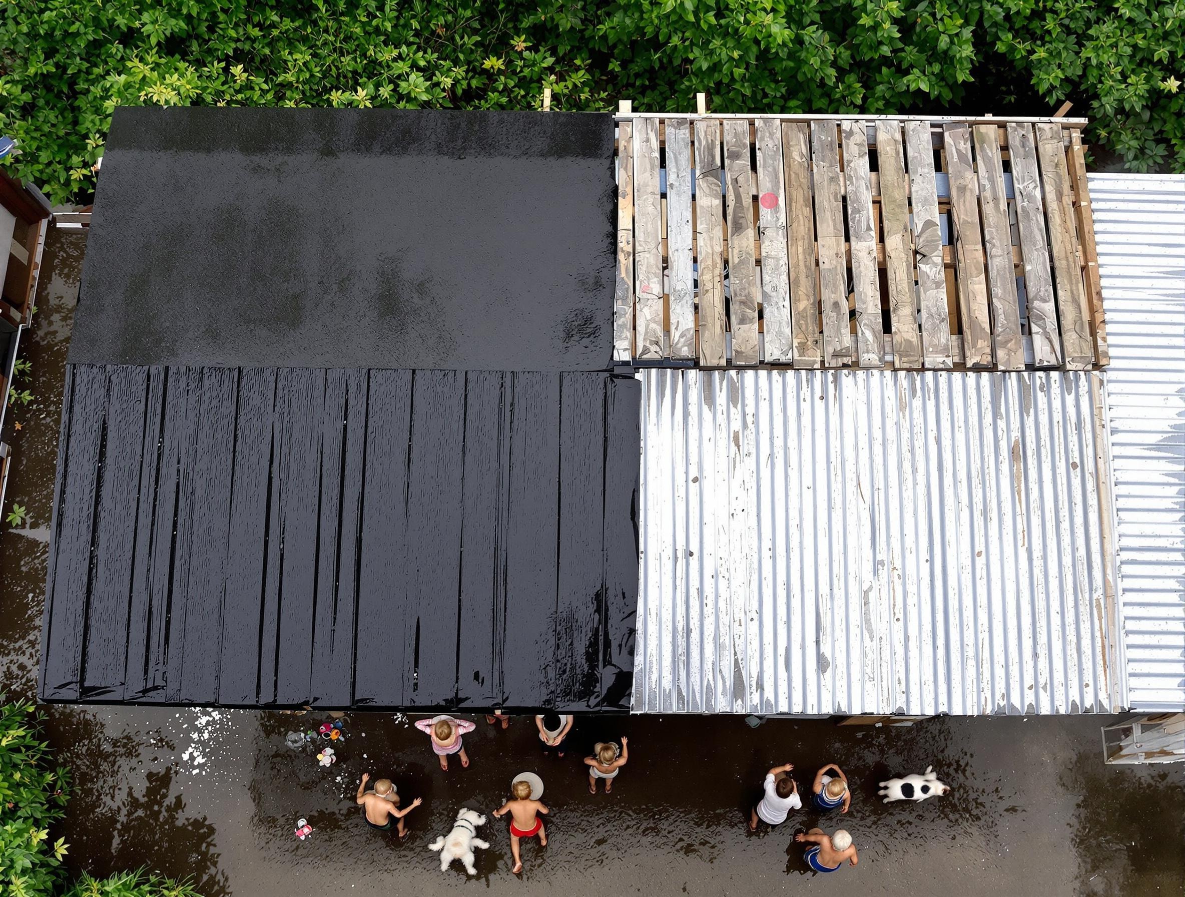 Toiture en palettes avec onduline et tôle, enfants jouant sous la pluie.